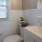 Bathroom with white tiled walls